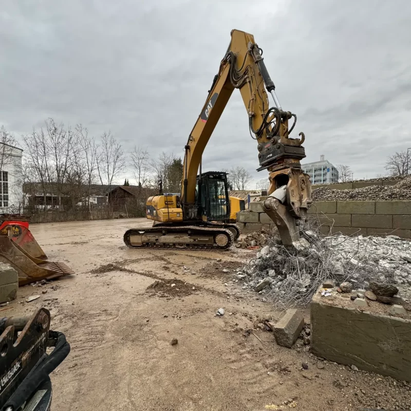 Gelber Bagger beim Recycling von Bauschutt. Home.